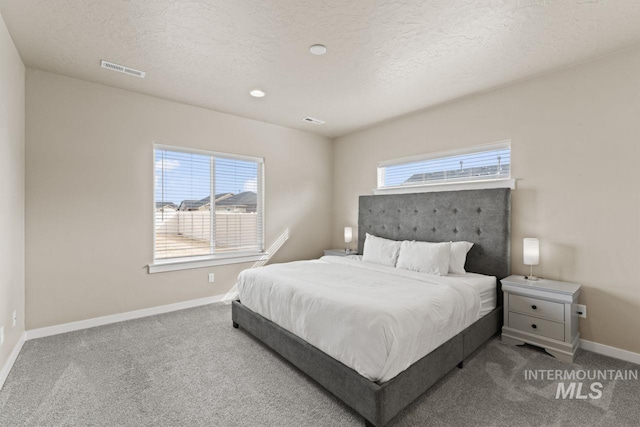 bedroom featuring visible vents, baseboards, and carpet