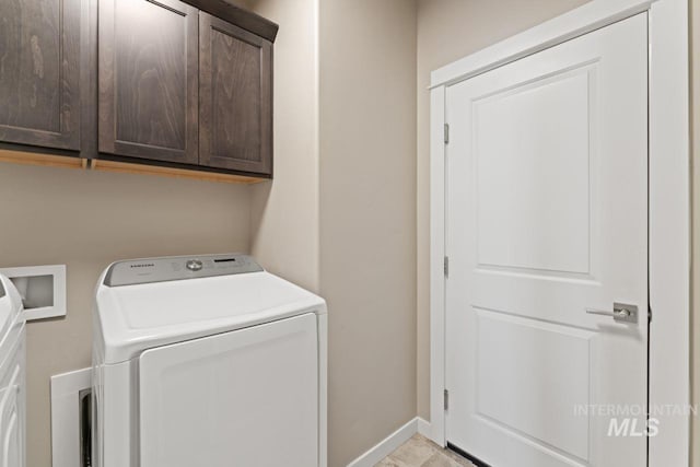 laundry room with cabinet space, washer / dryer, and baseboards