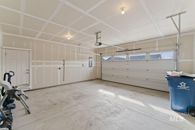 garage featuring electric panel and a garage door opener