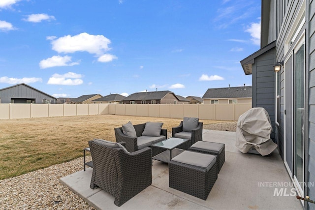 view of patio / terrace with area for grilling, an outdoor living space, and a fenced backyard