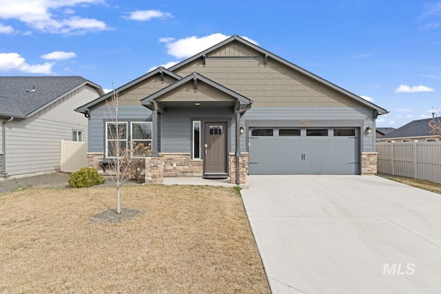 craftsman-style house with stone siding, concrete driveway, a garage, and fence