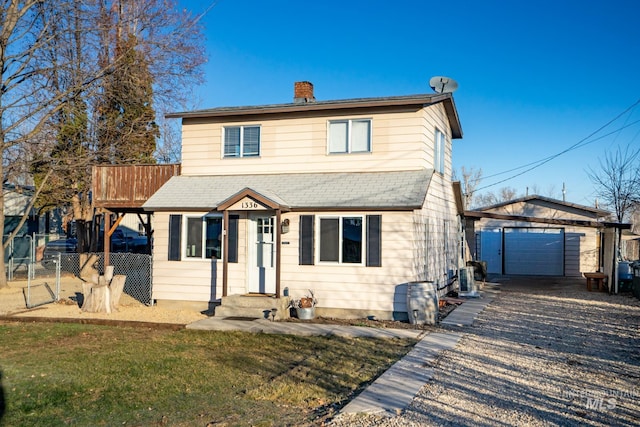 view of property featuring a garage, a front yard, an outdoor structure, and central air condition unit