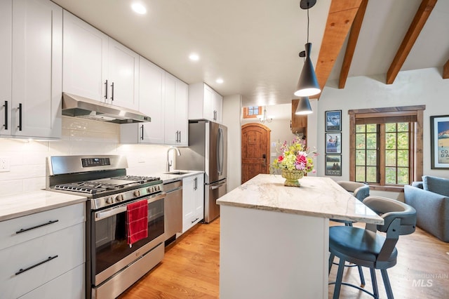 kitchen with white cabinets, pendant lighting, and appliances with stainless steel finishes