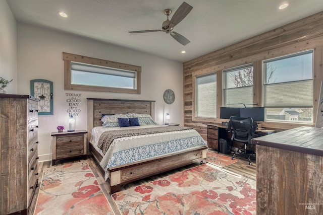 bedroom with multiple windows, recessed lighting, and wood finished floors