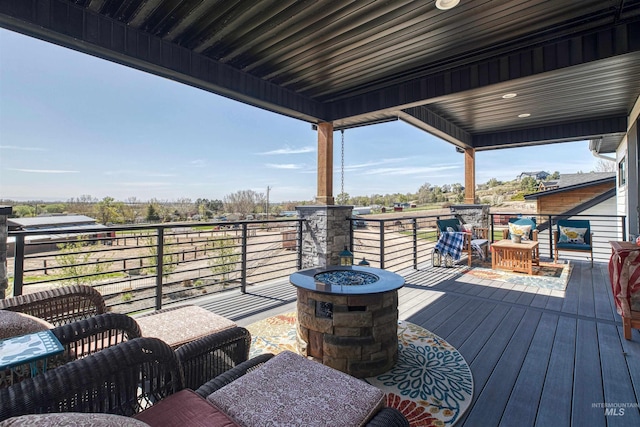 wooden deck with a fire pit