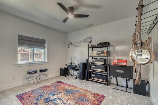 office area featuring visible vents, baseboards, ceiling fan, a textured ceiling, and carpet
