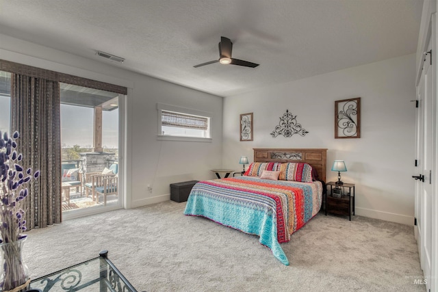 carpeted bedroom featuring visible vents, baseboards, ceiling fan, access to outside, and a textured ceiling