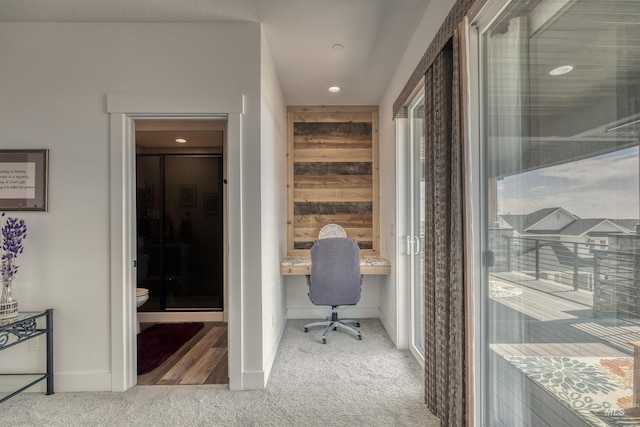 carpeted office with built in study area, baseboards, and recessed lighting