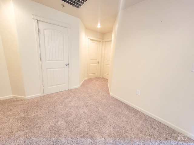 carpeted spare room with baseboards and visible vents