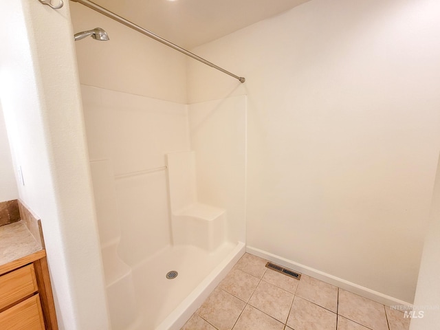 full bathroom featuring visible vents, a shower stall, vanity, tile patterned flooring, and baseboards