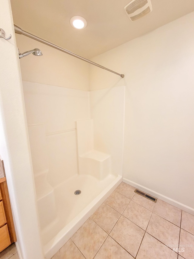 full bathroom featuring baseboards, visible vents, walk in shower, and tile patterned floors