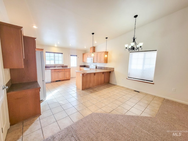 kitchen featuring a chandelier, a breakfast bar area, a peninsula, white appliances, and light countertops