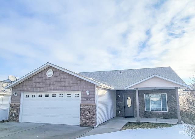 single story home with a garage, stone siding, a shingled roof, and driveway