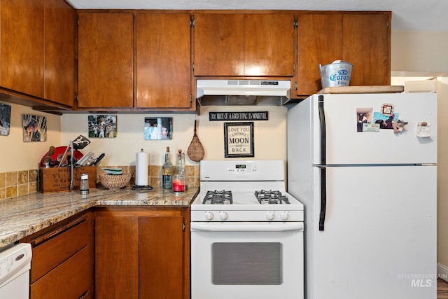 kitchen with white appliances and light stone counters