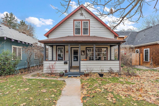 bungalow with a front lawn and a porch