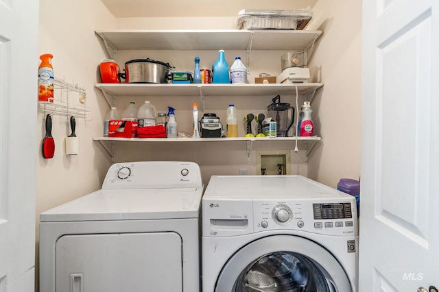 clothes washing area featuring separate washer and dryer