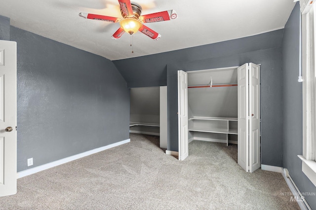 unfurnished bedroom with light colored carpet, vaulted ceiling, and ceiling fan