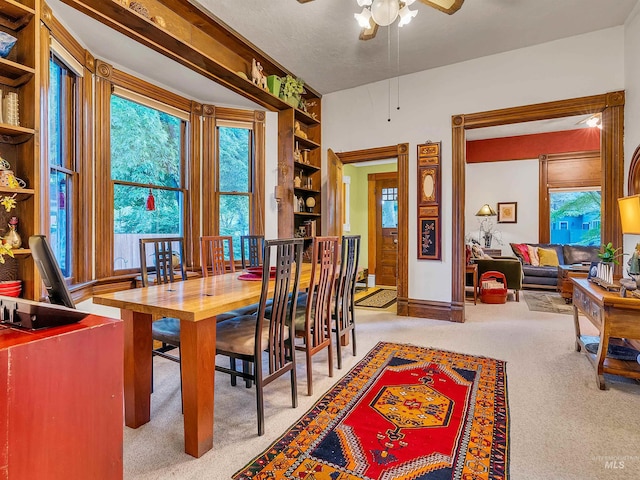 1408 N 7th St, Boise, ID 83702 - dining area featuring carpet flooring, a ceiling fan, built in shelves, and baseboards