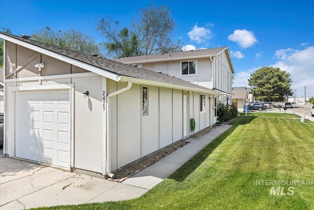 2429 Cherry St, Caldwell, ID 83605 - view of side of home featuring a lawn, board and batten siding, an attached garage, and roof with shingles