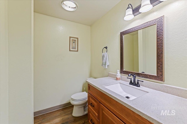 2429 Cherry St, Caldwell, ID 83605 - bathroom with toilet, vanity, and wood finished floors