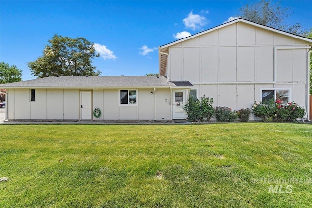2429 Cherry St, Caldwell, ID 83605 - rear view of house with board and batten siding and a lawn
