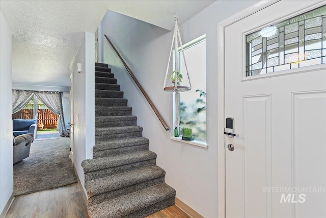 2429 Cherry St, Caldwell, ID 83605 - foyer entrance featuring stairway, wood finished floors, and a textured ceiling