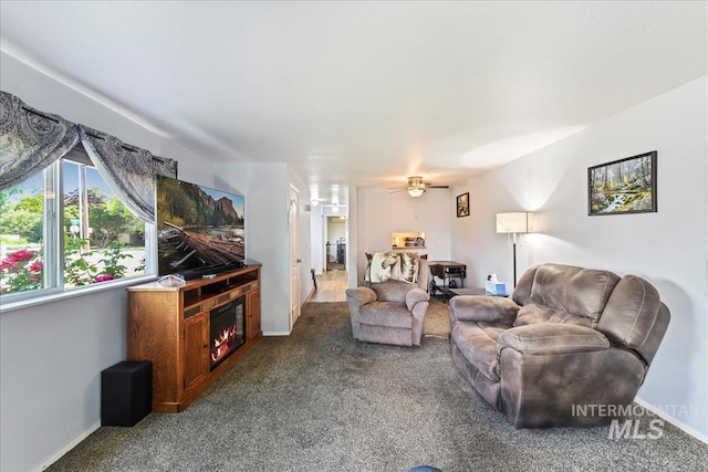 2429 Cherry St, Caldwell, ID 83605 - living area with carpet floors, a ceiling fan, a glass covered fireplace, and baseboards