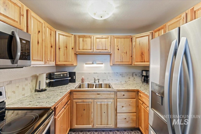 2429 Cherry St, Caldwell, ID 83605 - kitchen with stainless steel appliances, a sink, light brown cabinets, and light countertops