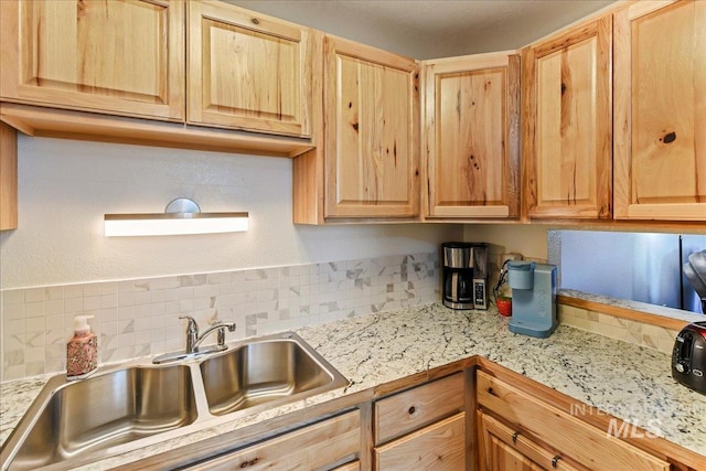 2429 Cherry St, Caldwell, ID 83605 - kitchen with light countertops, a sink, light brown cabinetry, and decorative backsplash