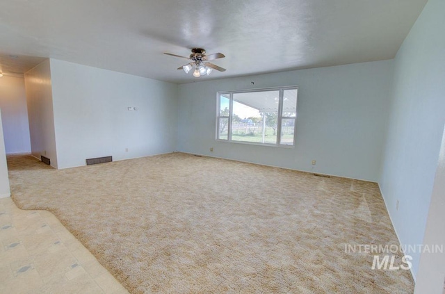 empty room featuring light carpet and ceiling fan