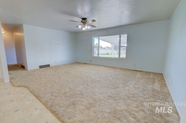 unfurnished room featuring ceiling fan and light colored carpet