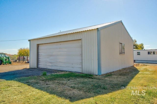 garage featuring a lawn