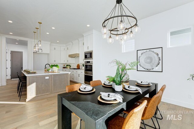 14241 N Woodpecker Ave, Boise, ID 83714 - dining area with a chandelier, recessed lighting, light wood-style floors, and baseboards