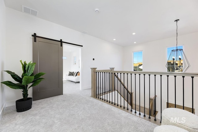 14241 N Woodpecker Ave, Boise, ID 83714 - hall with a chandelier, a barn door, carpet flooring, an upstairs landing, and recessed lighting