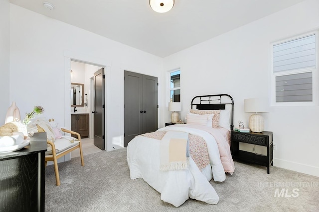 14241 N Woodpecker Ave, Boise, ID 83714 - bedroom featuring light colored carpet, ensuite bath, and baseboards