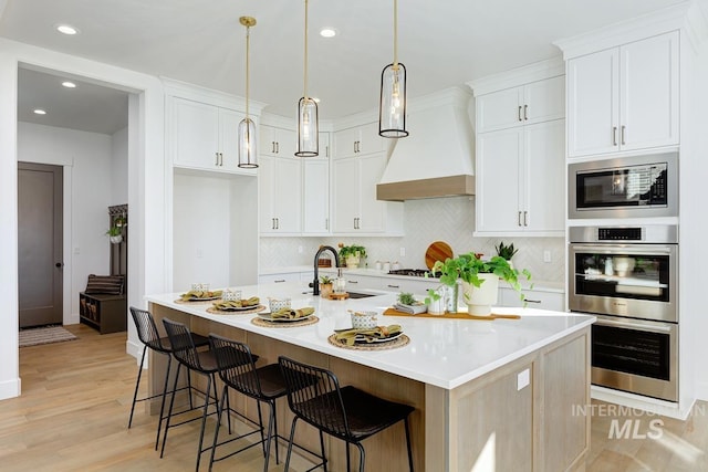 14241 N Woodpecker Ave, Boise, ID 83714 - kitchen with double oven, premium range hood, built in microwave, backsplash, and a sink
