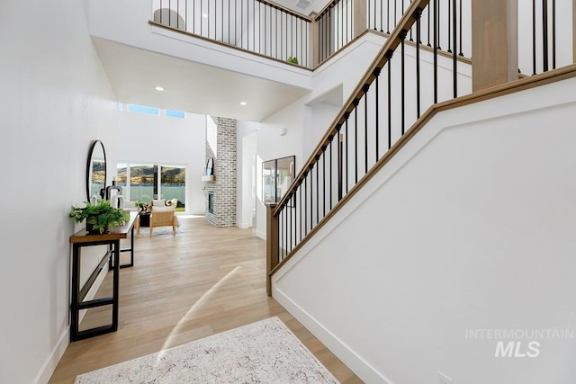 14241 N Woodpecker Ave, Boise, ID 83714 - staircase featuring a high ceiling, baseboards, and wood finished floors