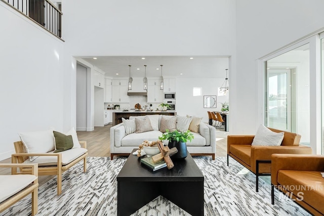 14241 N Woodpecker Ave, Boise, ID 83714 - living area featuring a high ceiling, light wood-style floors, recessed lighting, plenty of natural light, and baseboards