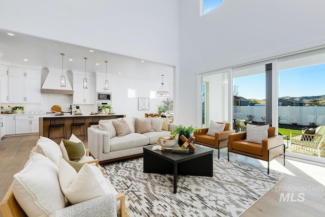 14241 N Woodpecker Ave, Boise, ID 83714 - living area featuring light wood-style floors, recessed lighting, and a high ceiling