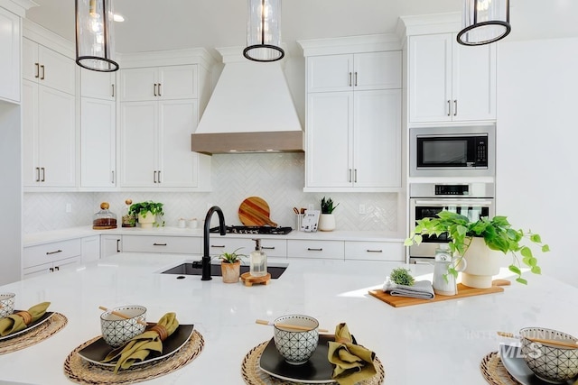 14241 N Woodpecker Ave, Boise, ID 83714 - kitchen with stainless steel oven, built in microwave, custom exhaust hood, and light countertops