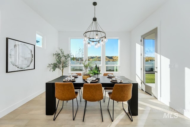 14241 N Woodpecker Ave, Boise, ID 83714 - dining area featuring a chandelier and baseboards
