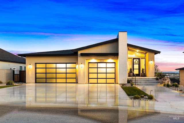 3501 E Planet Dr, Boise, ID 83712 - contemporary house featuring an attached garage, stucco siding, and concrete driveway