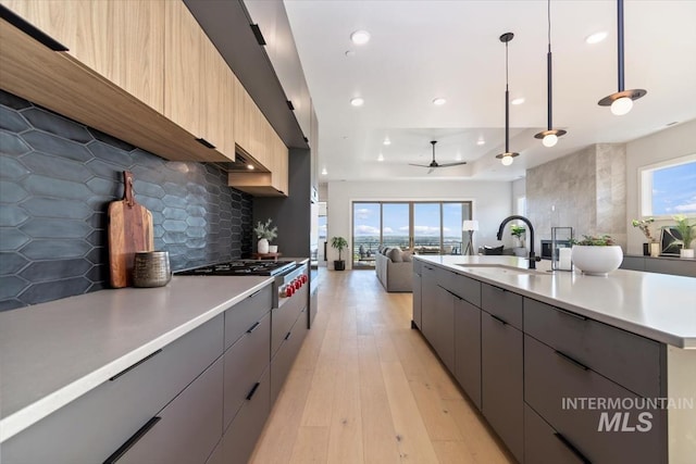 3501 E Planet Dr, Boise, ID 83712 - kitchen featuring modern cabinets, a sink, stainless steel gas cooktop, light countertops, and recessed lighting