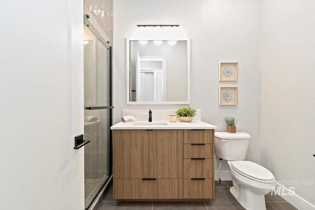 3501 E Planet Dr, Boise, ID 83712 - bathroom with vanity, toilet, a shower stall, tile patterned floors, and baseboards