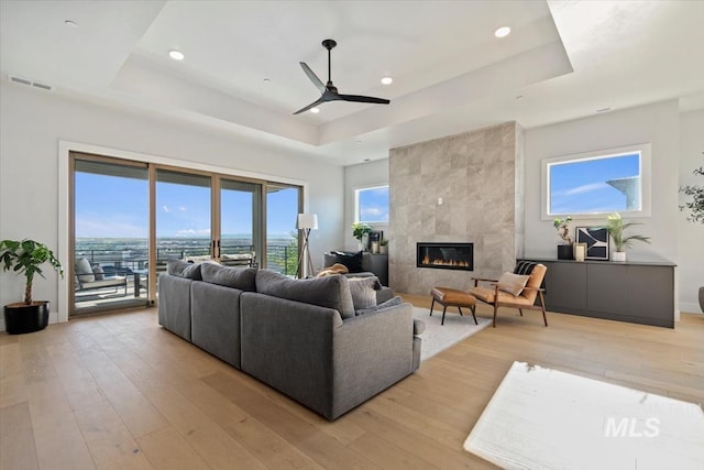 3501 E Planet Dr, Boise, ID 83712 - living area with a raised ceiling, light wood-style floors, ceiling fan, and recessed lighting