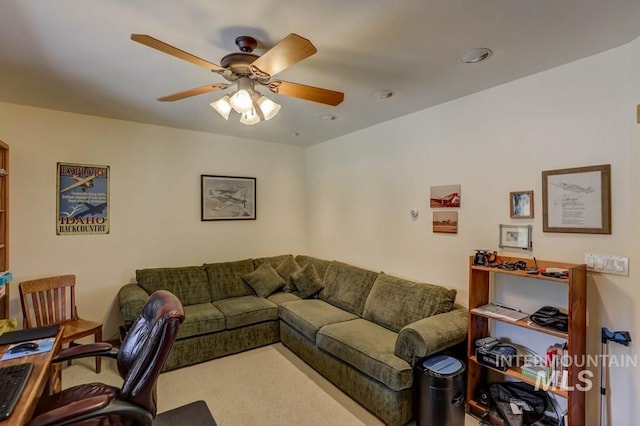 carpeted living room with ceiling fan