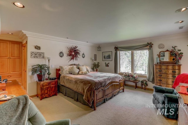 bedroom featuring light carpet and ornamental molding