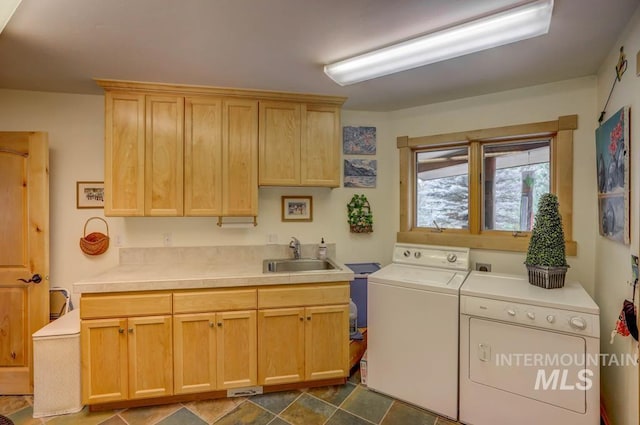 washroom featuring washing machine and clothes dryer, cabinets, tile floors, and sink