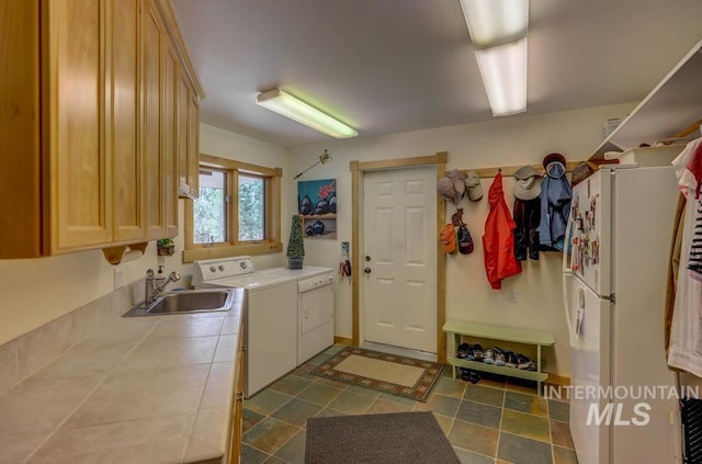 interior space with tile countertops, tile floors, white fridge, and sink