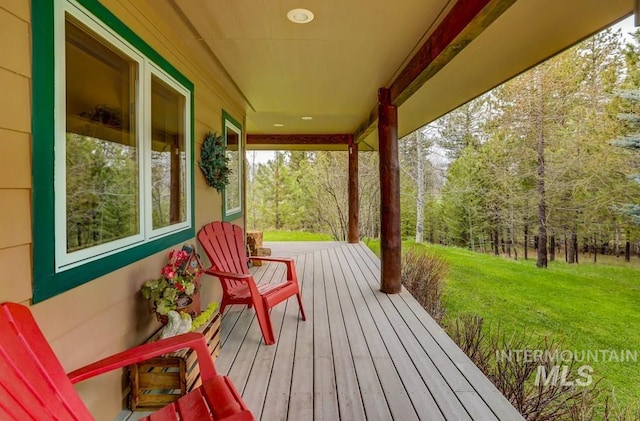 wooden terrace with a yard